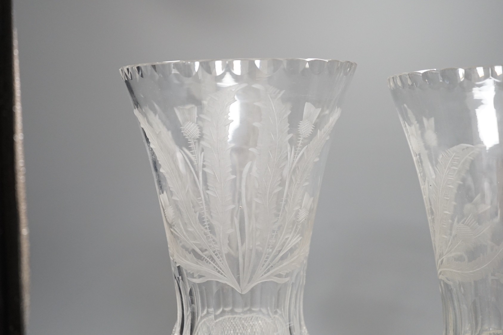 A pair of thistle engraved and cut glass storm lamps - 35cm tall